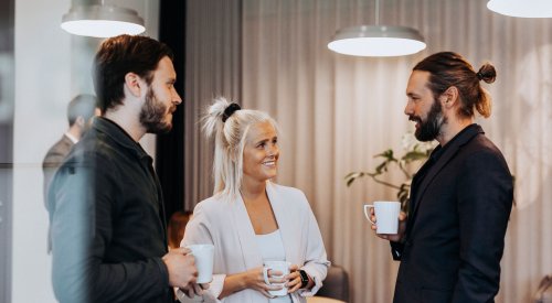 Kolleger snakker sammen over en kaffekopp